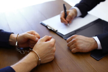 Handcuff client talking to his lawyer.