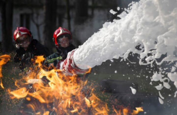 Firefighters extinguish a fire.